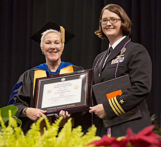 President Kolovani presents Cmdr. Shannon Wiens with an Associate of Science in Science. 