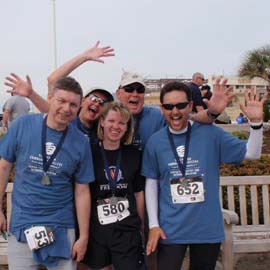 Runners wave and pose before a 5K race