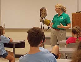 Margie Gomez shows off a red-tailed hawk.