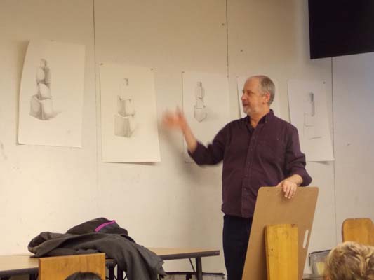 Robert Hawkes in front of a Drawing I class