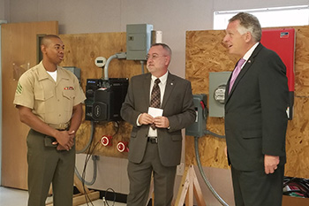 A TCC student talks with Gov. McAuliffe and Dean Thomas Stout about the solar program