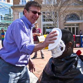 Man puts a pie on the face of math professor Coby Dillard