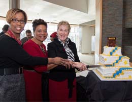 Provost Woodhouse, Student Center Director Katina Barnes and President Baehre-Kolovani prepare to cut the cake after the dedication ceremony.