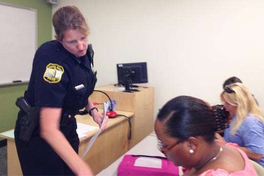 Virginia Beach Police Officer Helen Gillespie helps a student during class