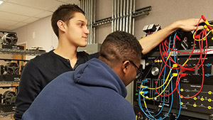 Two students working on a mechatronics board
