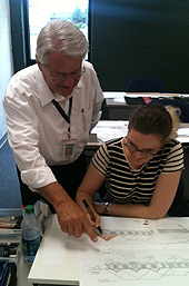 A TCC interior design student works on drawing techniques with her instructor.