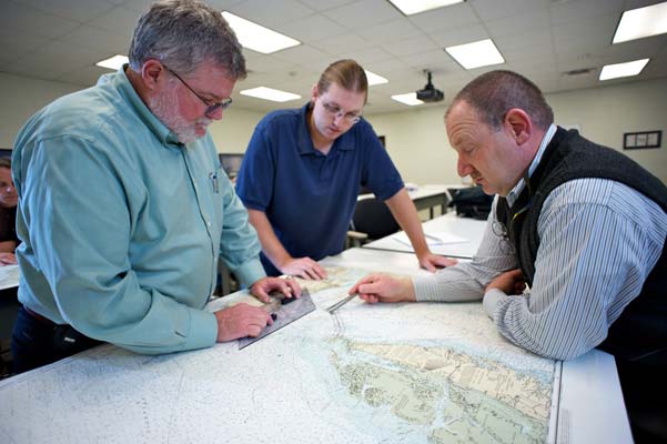 Instructor Stan Gold (right) teaches navigation skills to students at the Maritime Training Program at the Virginia Beach Campus