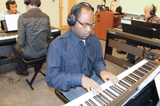 Students practice in the new piano lab on the Norfolk Campus.