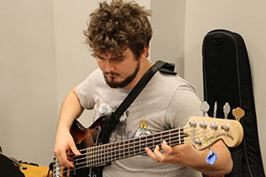 student playing the bass guitar