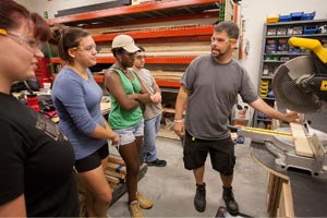  Matt Gorris instructs students on the proper use of tools when building sets