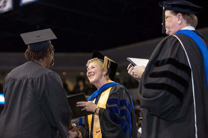 President Edna Baehre-Kolovani congratulates a graduate