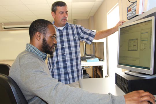 Professor Bill Simmons working with engineering student Lionel Brookins on the Chesapeake Campus
