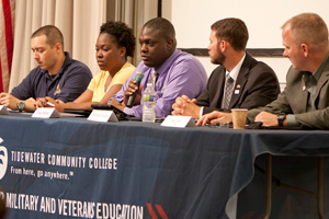 A panel of five veteran students sit at a table