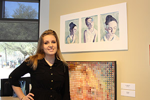 Kirsten Whitehouse posing with her painting
